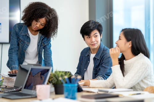 Preview: A happy Afro-American and multi-ethnic business men and women working together online on laptops in