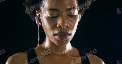 Preview: Earphones, fitness and black woman rest in studio for intense training, exercise and workout. Sport