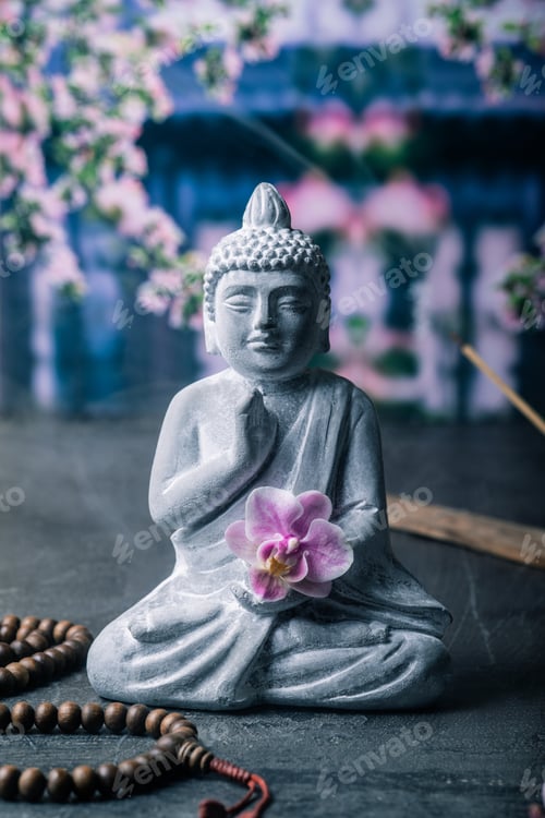 Preview: stone statue of buddha on a stone window sill surrounded by flowers and smoke - asian celebrations