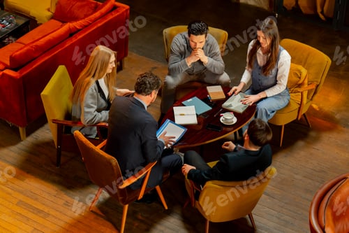 Preview: top shot in large beautiful hall office employees sitting on yellow chairs discuss a deal
