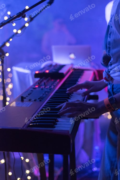 Preview: Musician playing live at a club, keyboard, stage.