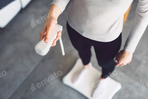 Preview: Unrecognizable young woman playing games on smart home devices holding a control in her hands standi