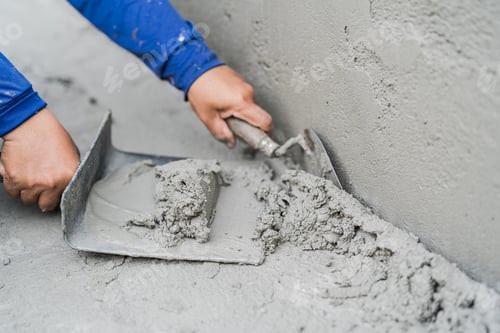 Preview: Hand worker plaster cement concrete with trowel tool well space for text