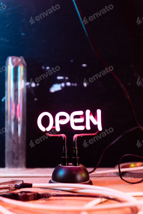 Preview: A Neon Open Sign On A Wooden Table