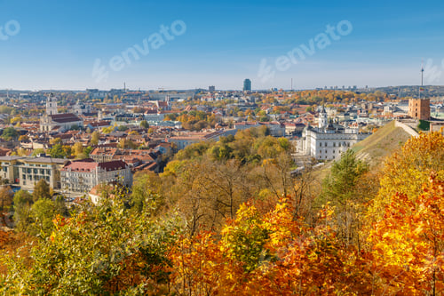 Preview: Autumn view of Vilnius showcasing vibrant foliage and cityscape under clear blue sky
