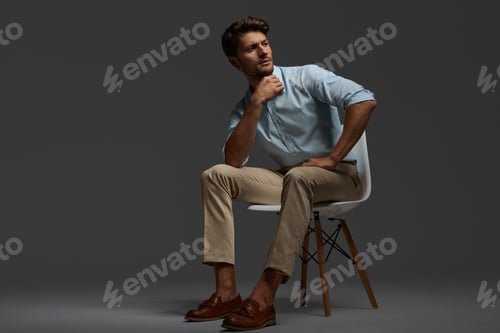Preview: Thoughtful european business man sitting on chair