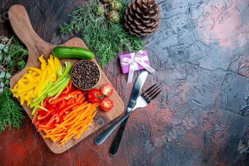 Preview: top view colorful cut peppers black pepper tomatoes cucumber on cutting board small gift fork and