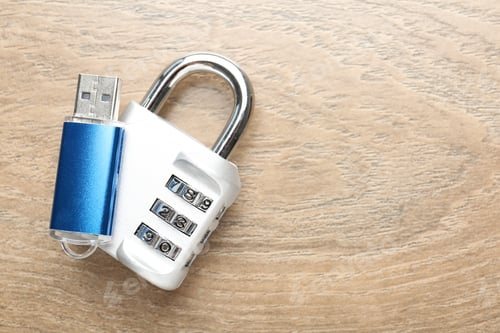Preview: Flash drive and combination padlock on wooden background, top view. Space for text