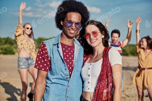 Preview: Portrait of smiling young couple on the beach party