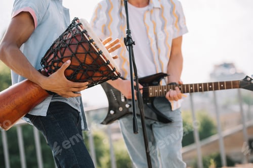 Preview: Cropped view of multiracial men performing on sunny city street