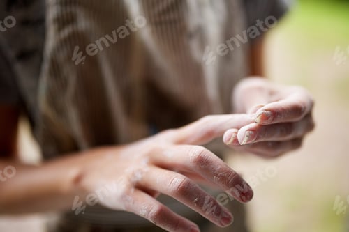 Preview: young girl hands cleaning clay from fingers