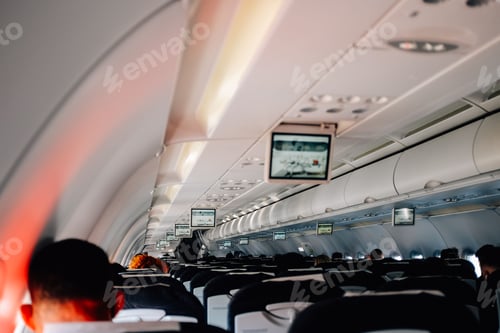 Preview: Indoor shot of a half-full, modern airplane passenger are