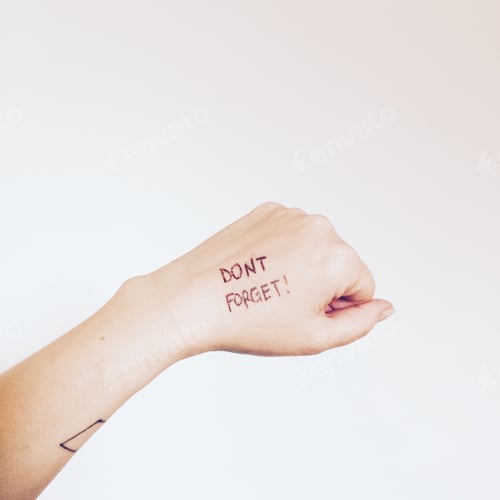 Preview: Reminder Written on Hand against White Background