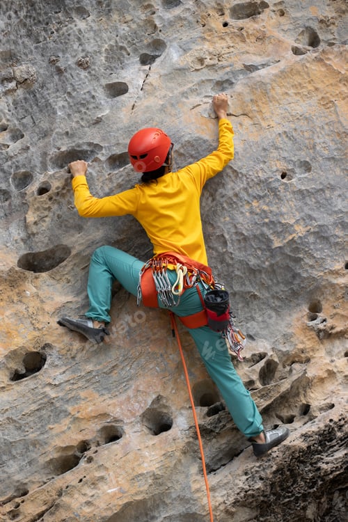 Preview: Woman rock climber climbing on the cliff