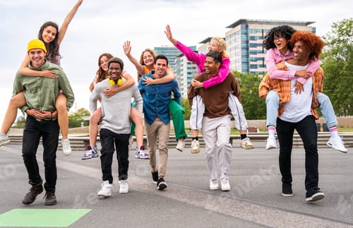 Preview: Happy playful multiethnic group of young friends bonding outdoors