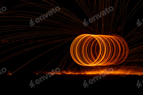 Preview: Orange circle moving light fire trails on black background