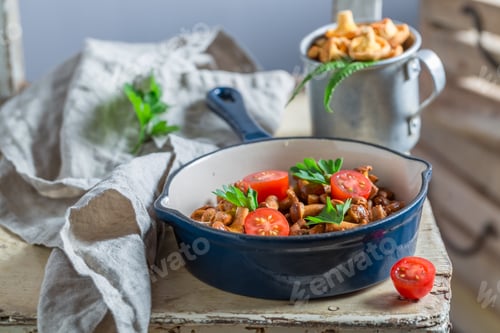 Preview: Delicious fried mushrooms with cherry tomatoes and parsley
