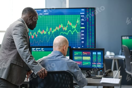 Preview: Two Men Working With Trading Charts
