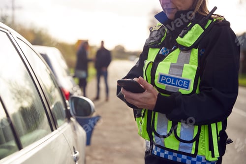 Preview: Female Traffic Police Officer Recording Details Of Road Traffic Accident On Mobile Phone