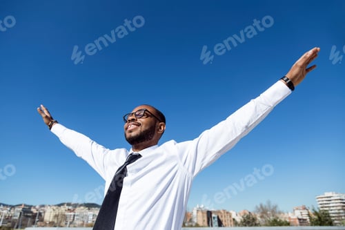 Preview: Happy young black man in white shirt