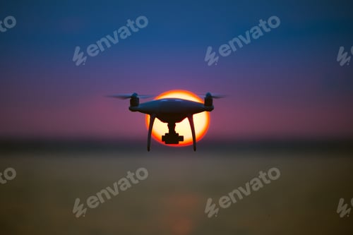 Preview: The drone flighting on the sunset background
