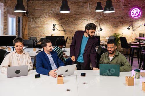 Preview: Multi ethnic team collaborating on project in modern office