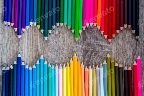 Preview: Multi Color pencils in scale with rainbow style isolated on wooden background