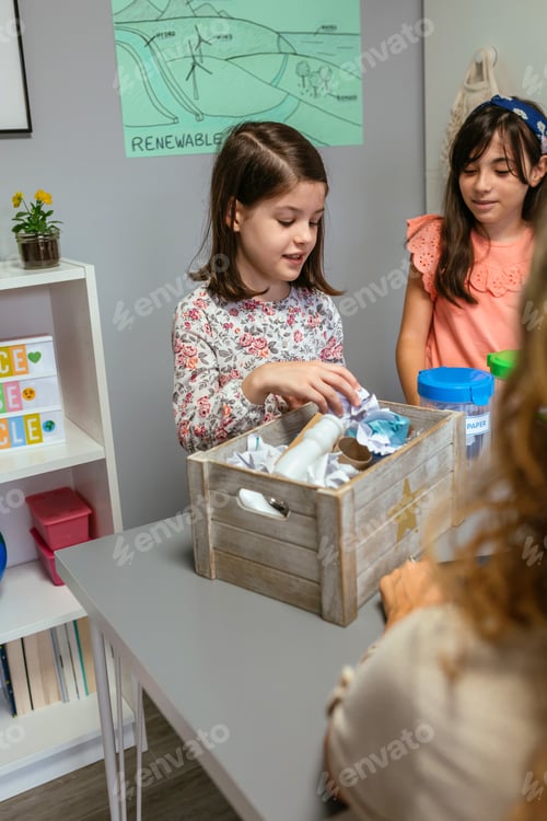 Preview: Students showing how to recycle in ecology classroom with her teacher in foreground