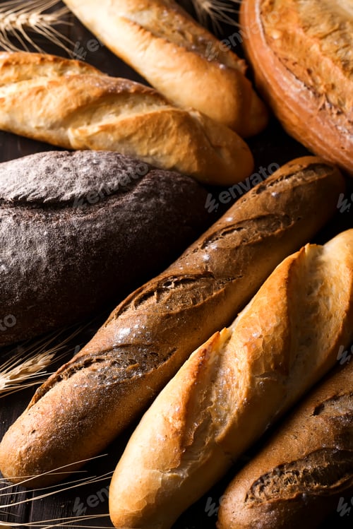 Preview: Fresh baked bread background, variety of different kind of breads, food industry
