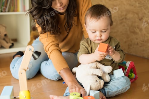 Preview: Woman and Baby Playing with Toy Blocks
