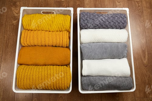 Preview: Baskets with neat stacks of knitted woolen clothes . Organization of order