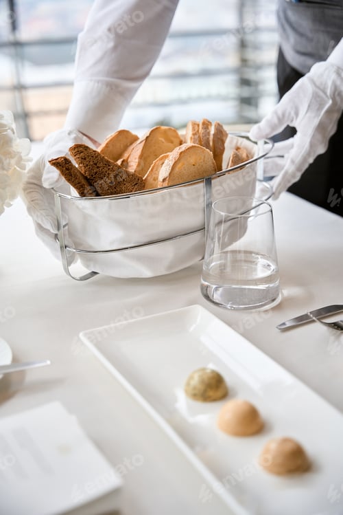 Preview: Fresh bread in basket on banquet. Table served in restaurant with tasty meals