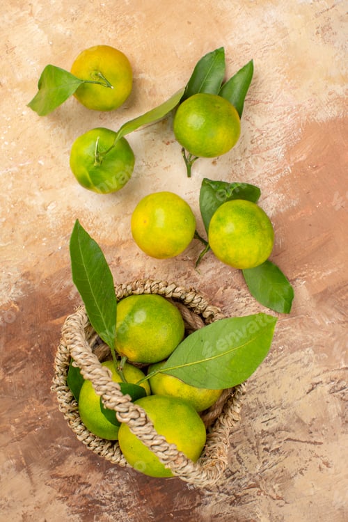 Preview: top view fresh green tangerines inside basket on the light background photo color mellow fruit juice