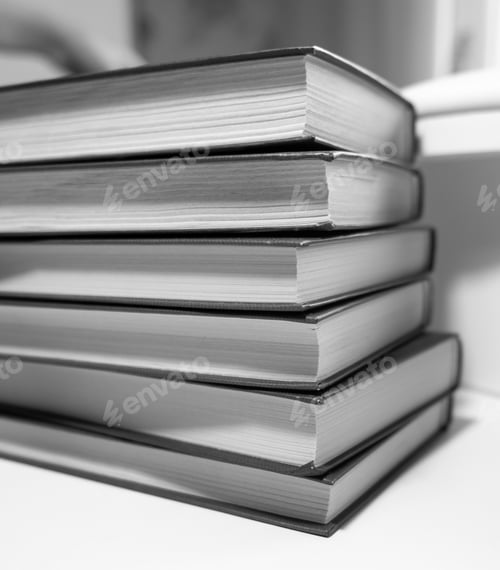 Preview: Stack of books on a white background. One book is yellow.