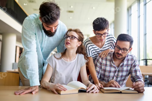 Preview: Happy university students studying with books in library. Group of multiracial people in college