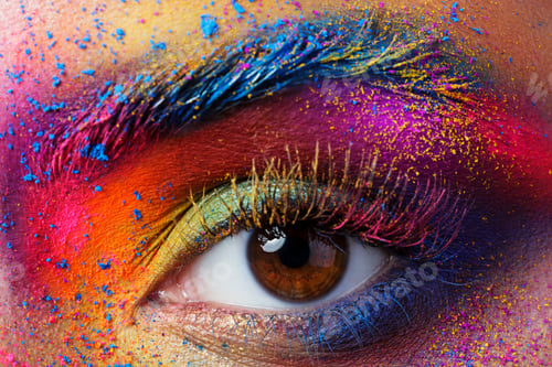 Preview: Close up view of female eye with bright multicolored fashion mak