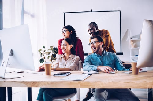 Preview: smiling multiracial business team working on project together in office