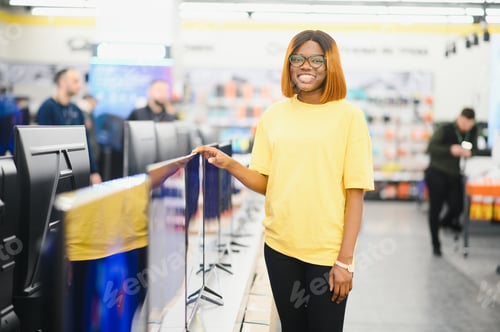 Preview: woman chooses plasma in store of household appliances, electronics and gadgets