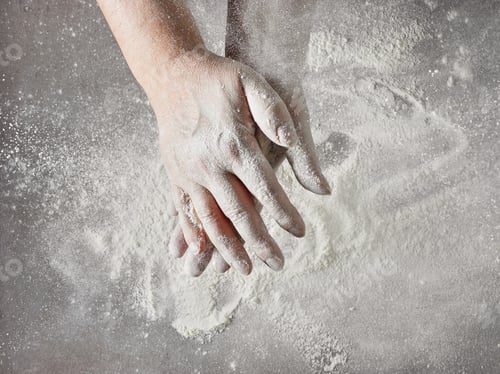 Hands Working with Flour on a Grey Surface