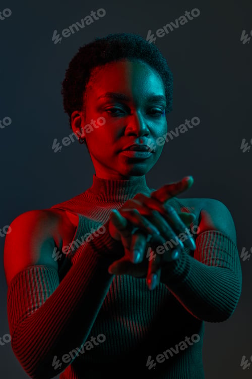 Preview: Stylish young woman in blue red neon light