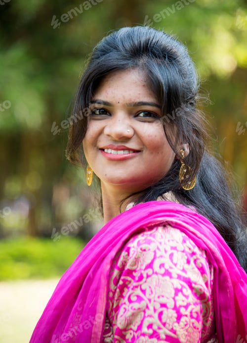 Preview: Outdoor portrait of beautiful young Indian girl in traditional dress.