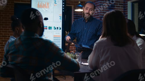 Preview: Businessman presenting analytics research, showing statistics on laptop screen