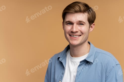 Preview: Positive successful caucasian man standing, looking at camera with happy smile