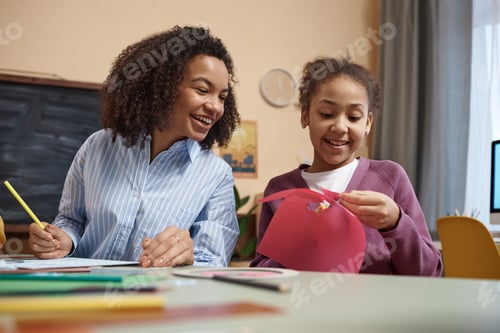 Preview: Black young woman with little girl enjoying DIY
