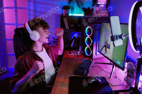 Preview: Caucasian Teen Boy Live Streaming Video Game and Celebrating Victory at Home
