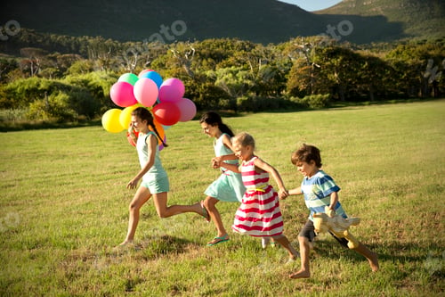 Preview: Happy children running with balloons on meadow