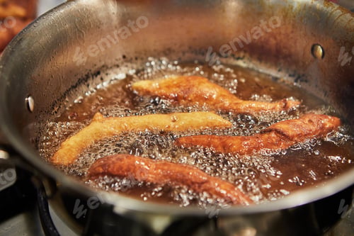 Preview: Bugnes, French donuts in boiling oil in saucepan
