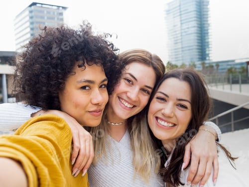 Preview: Group of three diverse female friends having fun and taking a selfie. Friendship, vacation