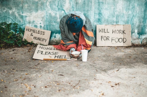 Preview: The beggars sat beside the street with a homeless message. Please help and work with food.