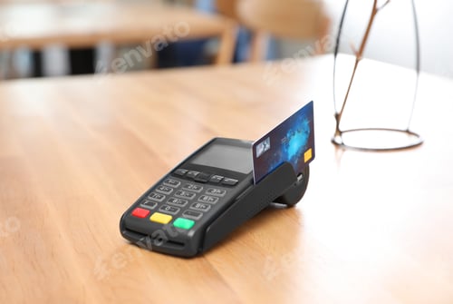 Preview: Credit card machine for non cash payment on wooden table indoors